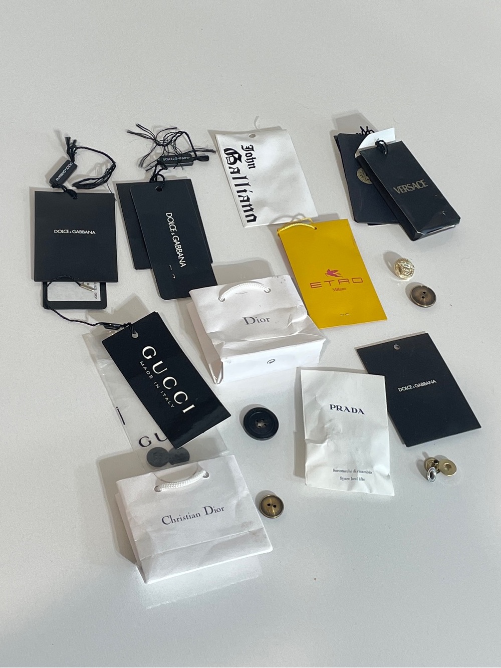 Lot of buttons from 7 different brands: Gucci, Prada, Dolce & Gabbana, Versace,